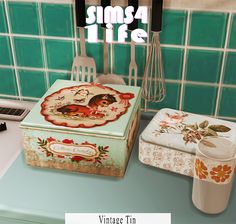 an old fashioned tin box sitting on top of a counter next to a kitchen utensil