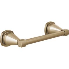 an antique brass toilet paper holder on a white background