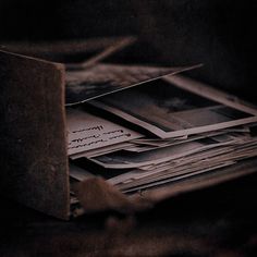 black and white photograph of books stacked on top of each other