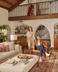 a man and woman are sitting in the living room