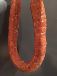 a large sausage hanging from the side of a wall