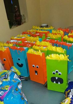 many bags with faces are lined up on the floor next to each other and candy