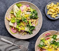 two plates filled with salad on top of a table