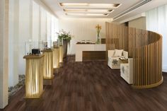 a room with wooden flooring and white walls in the background is a reception area