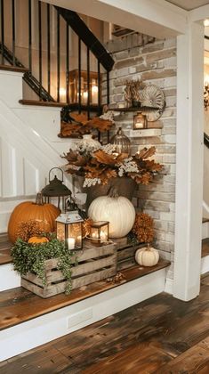 a staircase with pumpkins, candles and other fall decorations on the bannisters