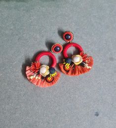 Bohemian handmade Red and black floral raffia earrings. These faded red raffia floral earrings are ideal for the  summers and holidays. The earrings are handmade of raffia, cotton polyester fabric, glass, brass, paper, wood etc with intricate workmanship. Earrings measure approx. 3.25" long and 2.50" wide. PS : Be noted, these are sampling and stock pieces for the past two years but are in reasonably good condition with a slight color variation with antique metallic parts. This is the reason that these are sold at the one third of the actual price. Please refer to the pictures and videos to understand the quality. At Carnation jewellery, each piece is designed and handcrafted in house by me and my artisan team with love and care in India.  * SHIPPING - Please refer to the "announcement" pa Handmade Red Bohemian Flower Earrings, Red Bohemian Drop Flower Earrings, Bohemian Red Flower Earrings, Bohemian Red Embroidered Jewelry, Red Flower-shaped Earrings With Handmade Flowers, Cotton Polyester Fabric, Bohemian Handmade, Floral Hoops, Red Earrings