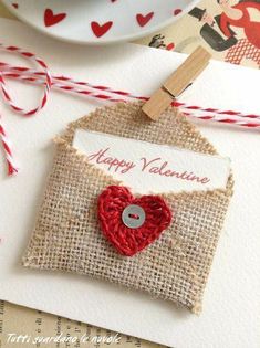 a valentine's day card with a red heart on it, hanging from a clothesline