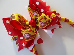 a close up of a bow on a white background with red and yellow polka dots