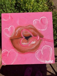 a painting of a woman's lips with hearts painted on the outside of it