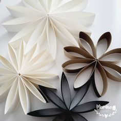 three paper flowers sitting next to each other