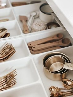 silverware and spoons are stored in the drawers