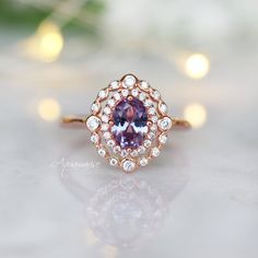 Beautiful Vintage Inspired Alexandrite Ring ►Can be paired with one or two half-eternity Milgrain bands of your choice (select option from a drop menu) ►Base Metal: Sterling Silver (S925) ►Plating: 14K Rose Gold Vermeil ►Accented With Simulated Diamonds Center Stone: Alexandrite Stone Cut: Oval Gem size: 7.0 x 5.0 mm Carat Weight: 0.76 (approx.) Gemstone creation: 100% Genuine Lab-Grown Alexandrite Stone Origin: Russia Hardness: 8.5 (Mohs scale) ►Handling time: 1-2 business days ►Free domestic s Timeless Amethyst Ring With Center Stone For Wedding, Timeless Amethyst Wedding Ring With Center Stone, Timeless Amethyst Ring For Wedding, Timeless Amethyst Ring With Accent Stones For Wedding, Timeless Amethyst Wedding Ring With Accent Stones, Heirloom Style Rose Gold Cluster Ring, Vintage Halo Promise Ring, Vintage Halo Ring For Promise, Anniversary Amethyst Ring With Rose Cut Diamonds