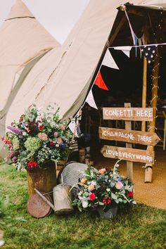 flowers are in buckets next to a sign that says come it here and champagne there