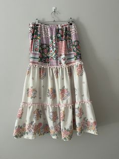 This gorgeous size 10 boho skirt is created from three pieces of vintage preloved sheets. The skirt is tiered from an elasticised waist band and each tier is trimmed with pompom trim.  The skirt also features inseam pockets.  The skirt is ankle length with a soft drape. Thi skirt is a very versatile piece and can be worn comfortably in any weather. Although this style is giving, the ideal measurements are: waist 64-67c, and hips 88-92cm. The skirt is available for $69 with free delivery in Australia Maxi Skirt Boho, Boho Chic Dress, Patchwork Skirt, Boho Skirts, Boho Maxi, Patchwork Dress, Vintage Fabrics, Size 10, Boho Chic