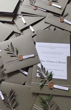 wedding stationery and envelopes are laid out on top of each other