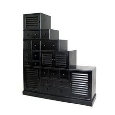 a black cabinet with drawers on the bottom and stairs up to it's top