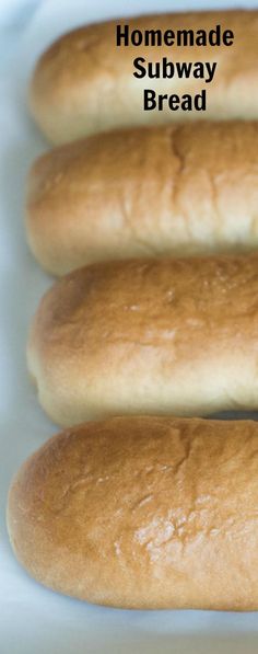 four loaves of bread sitting on top of a white tray with the words homemade subway bread