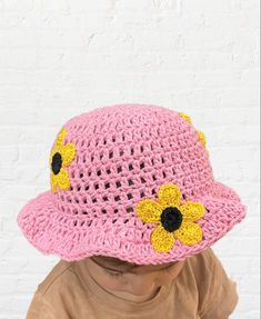 Pink crochet bucket hat with crochet sunflowers all made by hand. 12-18months #crochethatpattern #sunflower #buckethatsoutfit #pink #daisies #buckethat #crochetdesign #etsygifts #crochetforbaby #fashion #crochetclothes #blackownedbusiness #ecofriendlyfashion Cute Brimmed Crochet Beach Hat, Summer Crochet Cap Made Of Cotton Yarn, Knitted Crochet Hat For Vacation In Spring, Hand Knitted Adjustable Mini Hats For Spring, Adjustable Hand Knitted Mini Hats For Spring, Adjustable Hand-knitted Mini Hats For Spring, Spring Beach Crochet Hat With Flower Shape, Summer Hat With Crochet Lace, Spring/summer Crochet Yarn Hat