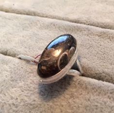 "Turritella Fossil aka Elimia Agate Ring Size 6.75 oval cabochon set in Sterling Silver. The stone itself measures 11mm wide (.45 inch) by 23mm long (.91 inch). Turritella Agate meaning: Despite its name, \"Turritella agate\" is not made of fossil snails of the genus Turritella. This has been realized by professionals and many amateurs for a long time, but the name (and the confusion it promotes) have persisted. The snails are actually properly referred to as Elimia tenera, in the family Pleuroc Turritella Agate, Agate Meaning, Agate Ring, Oval Cabochon, The Family, Fossil, Agate, Gemstone Rings, Ring Size