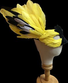 Custom Bird Mask Hi- Welcome to the shop where everything is handmade by Anne's hands. The piece shown is a yellow and black mask was made to depict the American Goldfinch.    Made from  goose feathers. The wing is 3D, extending about the mask and is slightly movable. Want another color bird- I can do it...  Send a custom request with your desired bird and colors. 📌Special request/contact me? Click the "Ask a question" link on the right. Customizable bird masks in any color you desire.  Tell me the kind of bird you like and I will customize the mask to fit your needs. 🧵handmade using traditional millinery techniques making a quality long lasting keepsake headpiece.  A little about me, the maker, Anne: 🎨I have a  BFA in Textiles from RISD. I have been working as a Broadway / theatrical m The Cher Show, Best Costume Design, Bird Masks, Bob Mackie, Goose Feathers, Black Mask, Goldfinch, Kinds Of Birds, I Can Do It