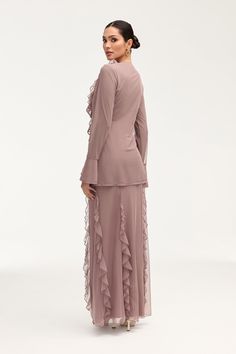 Indulge in the exquisite elegance of the Adriana Waterfall Mesh Maxi Skirt in Twilight Mauve. Crafted from delicate mesh fabric, this skirt features a cascading waterfall ruffle detail and flattering princess seams. Perfect for making a sophisticated statement at any event or occasion. Model is 5'7" and is wearing size S/44". Please note this garment runs tight. We kindly recommend choosing one size up from your usual size. Chic Wedding Skirt With Ruffles, Elegant Skirt With Ruffles, Flowy Party Skirt With Ruffles, Feminine Ruffled Evening Skirt, Elegant Skirted Dress With Ruffles, Elegant Ruffled Maxi Skirt, Elegant Maxi Skirt With Ruffles, Elegant Party Skirt With Ruffle Hem, Elegant Fitted Skirt With Layered Hem