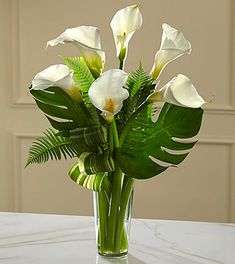 a vase filled with white flowers on top of a table