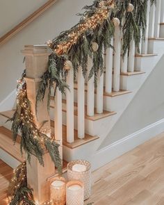 candles and garland on the banisters in front of stairs