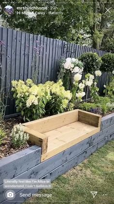 a wooden bench sitting in the middle of a garden