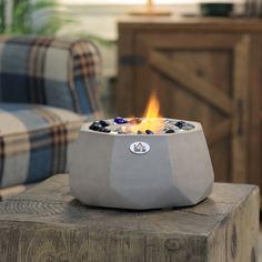 a fire pit sitting on top of a wooden table