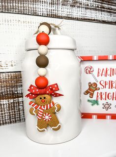 a cookie jar decorated with gingerbreads, candy canes and an ornament