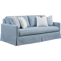 a blue couch with pillows on it and two white pillows sitting on top of it