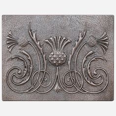 an intricately designed metal plate with flowers and leaves