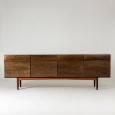 the sideboard is made out of wood and has four drawers