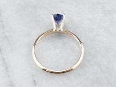 "This is a classic engagement ring with clean lines and great proportions! This ring is quite traditional, featuring a solid gold head to hold the stone securely. Polished yellow gold shoulders complete the simple look. We've set this versatile piece with an intense sapphire, an exquisite cornflower blue that is bright and shining. The value of this gem is found in its quality - this is a benchmark gem, of the ultimate color and clarity that other sapphires can be compared against. Metal: 14K Ye Engagement Ring Classic, Yellow Gold Sapphire Ring, Sapphire Solitaire Ring, Classic Engagement Ring, Gold Sapphire Ring, Ring Sapphire, Classic Engagement, Sapphire Solitaire, Cameo Ring