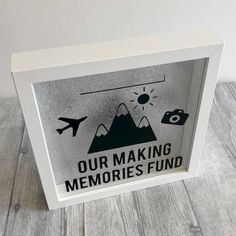 a white frame with the words our making memories fund on it and an airplane flying over mountains