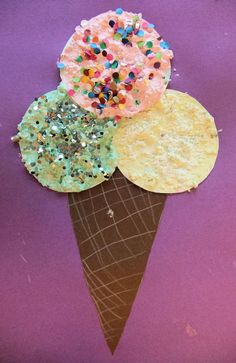 three ice cream cones with sprinkles and confetti on each cone