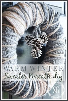 a yarn wreath with two pine cones on it and the words warm winter sweater wreath diy