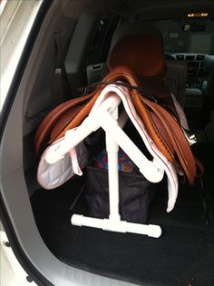 the back seat of a car with luggage in it's trunk and an umbrella