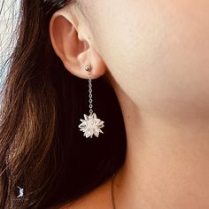 This stunning pair of snow flower dangle drop earrings showcases a delicate snowflake or lotus flower crafted from luminous white crystals, suspended from a dainty chain made of high-quality 925 sterling silver with a luxurious platinum plating. Elevate your fine jewelry collection with these elegant white flower dangle drop earrings, or delight your loved ones with them as a thoughtful Christmas gift. Sold as a pairMaterials: 925 sterling silverFinish: platinum plateDimensions: 1.49 x 0.49 in J White Sterling Silver Dangle Flower Earrings, Elegant White Snowflake Earrings, Snow Flower, Thoughtful Christmas Gifts, Dainty Chain, White Crystals, Fine Jewelry Collection, White Flower, Flower Crafts