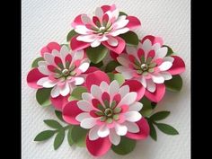 pink and white paper flowers with green leaves