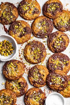 chocolate chip cookies with pistachios on a baking sheet, ready to be eaten