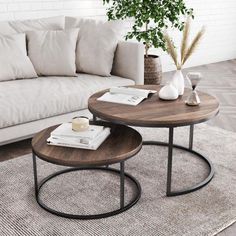 two coffee tables sitting on top of a rug in front of a couch and table