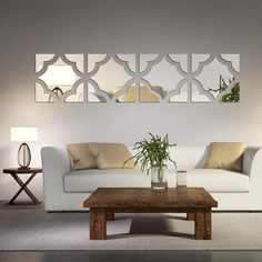 a modern living room with white furniture and mirrors