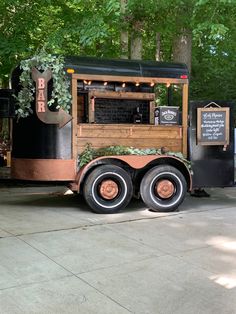 a food truck parked in front of some trees