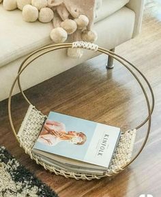 a book is sitting on the floor next to a chair with a teddy bear in it