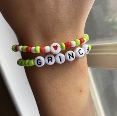 two bracelets with the word grin written in white, green, and red beads