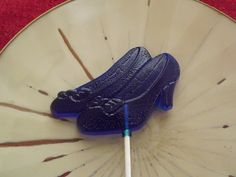 a pair of blue shoes sitting on top of a white plate next to a toothbrush