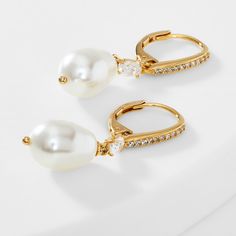 ABOUT THE PRODUCTThe perfect earrings for a special occasion or for a more refined daily look with a classic white pearl and just the right amount of sparkle. Metal: BrassPlating: 18KT Gold or RhodiumStones: Cubic Zirconia, White PearlLength: 1 1/4 inWidth: 1/4 in White Pearl Drop Earrings In Cubic Zirconia, Pearl White Pearl Drop Earrings With Cubic Zirconia, White Pearl Teardrop Earrings With Pearl Charm, Pearl White Teardrop Pearl Charm Earrings, Pearl White Teardrop Earrings With Pearl Drop, Teardrop Pearl Earrings For Anniversary, Brass Gold, Gold Drop Earrings, Pearl Drop Earrings