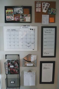 the wall is covered with magnets, pictures and other office supplies in black frames