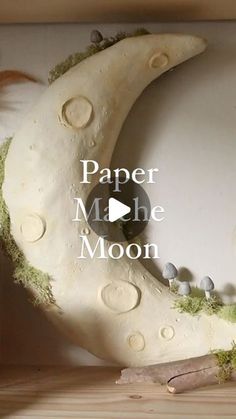 a fake moon with moss growing on it and the words paper mache moon above it